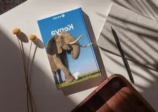Kenya Guidebook on top of a table Canva Pro