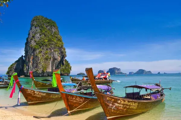 Longtail boats on phulet beach thailand unsplash