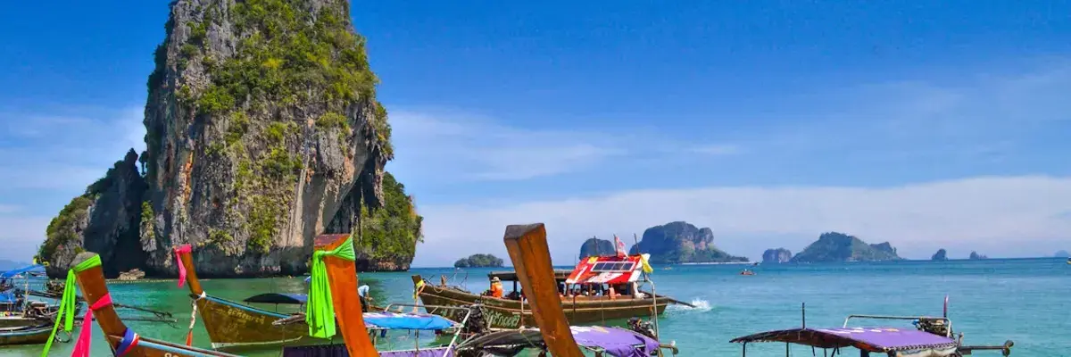 Longtail boats on phulet beach thailand unsplash