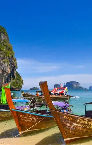 Longtail boats on phulet beach thailand unsplash