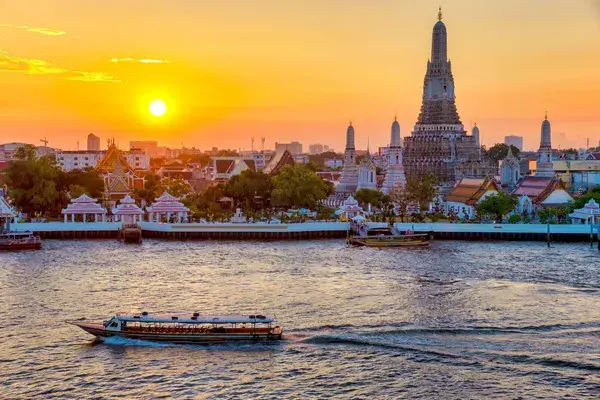 Wat Arun sunrise with riverboat Bangkok Thailand Canva Pro